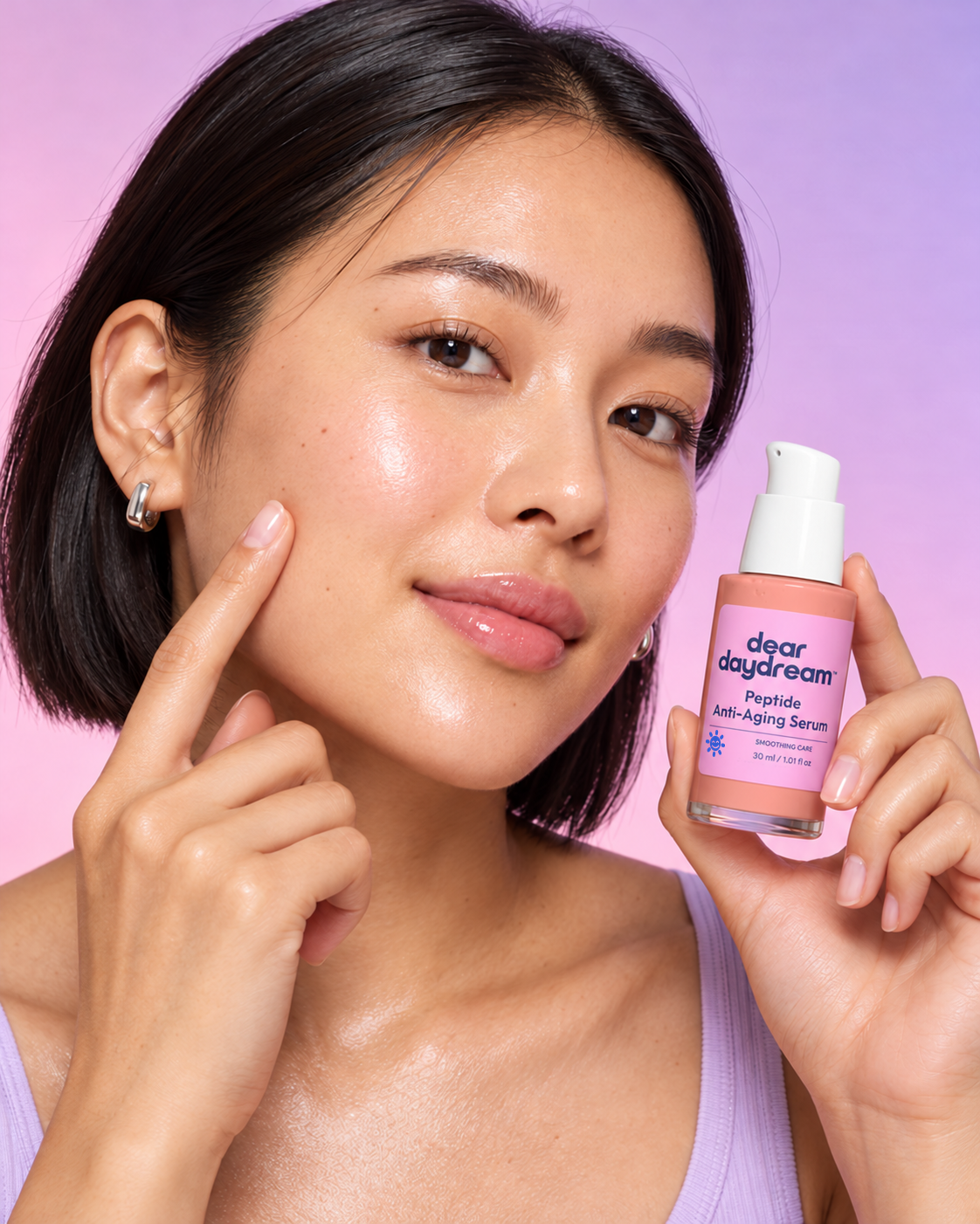 Woman with a short dark bob holding Dear Daydream Peptide Anti-Aging Serum