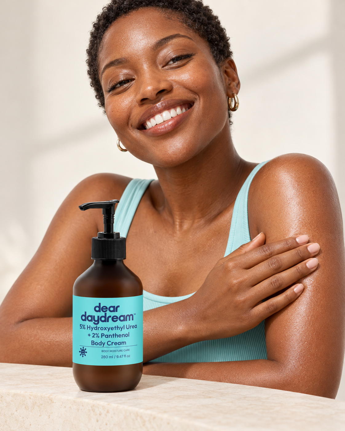 Smiling woman in turquoise with Dear Daydream Hydroxyethyl Urea and Panthenol Body Cream